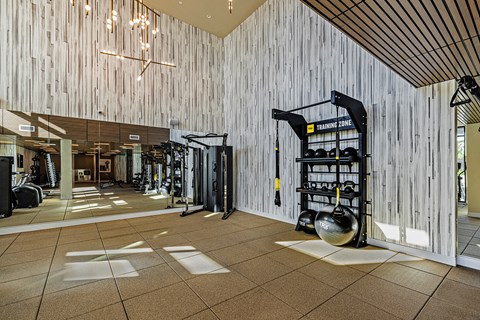 a gym with weights and equipment on the wall