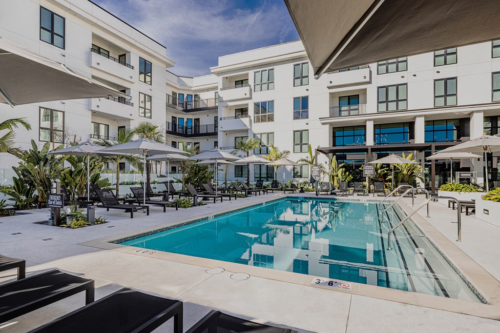 a large swimming pool in front of a building