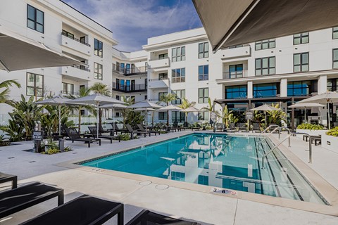 a large swimming pool in front of a building