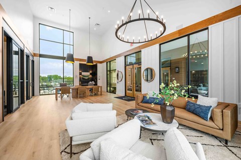 A modern living room with a white sofa and a wooden floor.