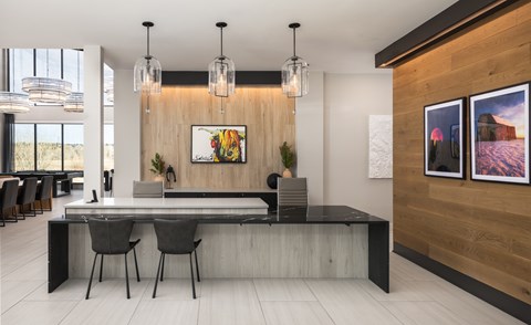 A modern dining room with a long table and chairs.