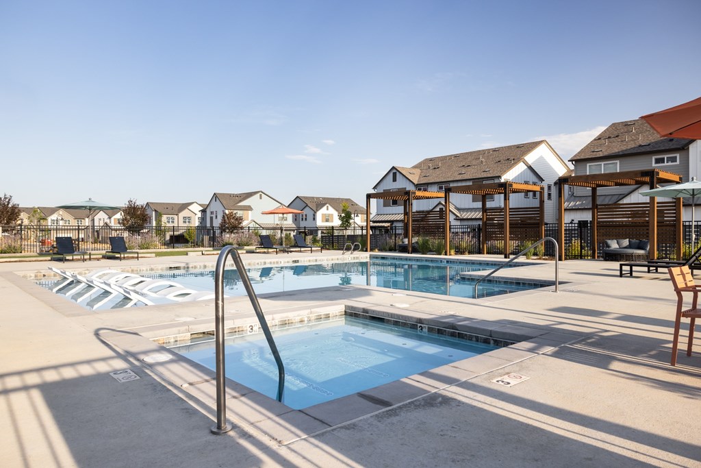 A swimming pool with a ladder and a bench.