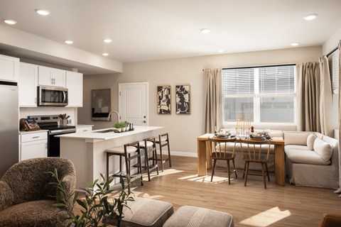A modern kitchen with a dining table set for two.
