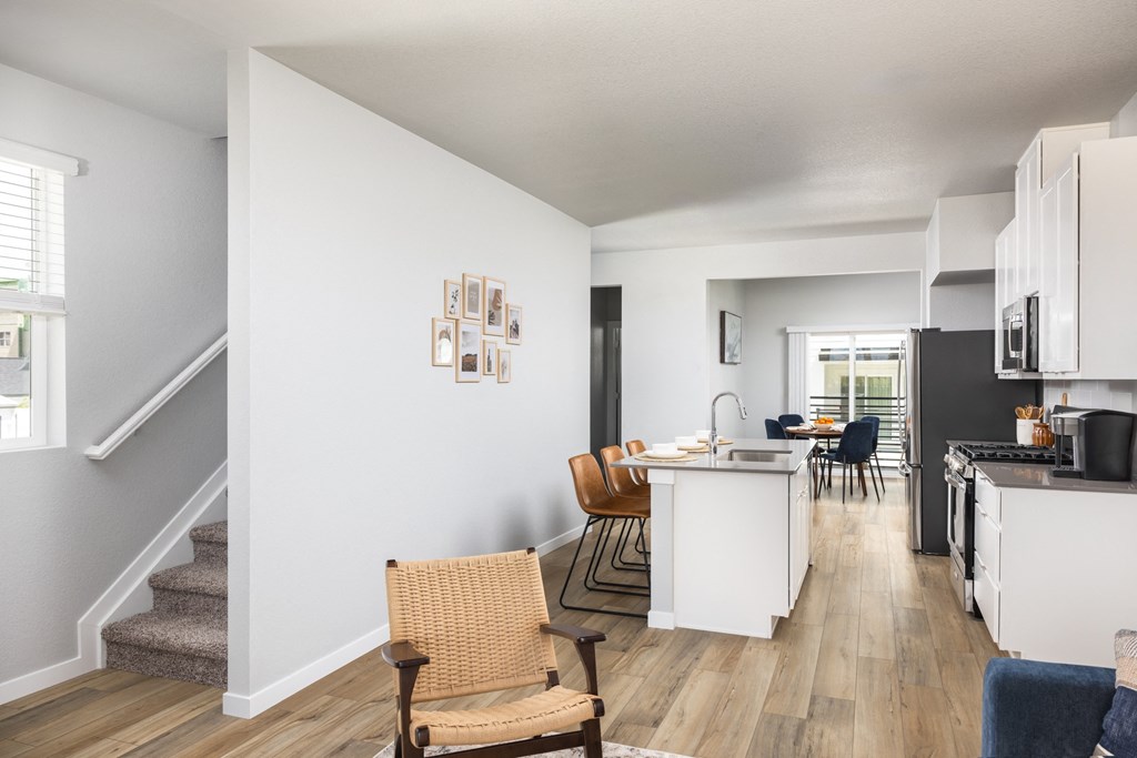 an open living room and kitchen with a dining area and a kitchen table and chairs
