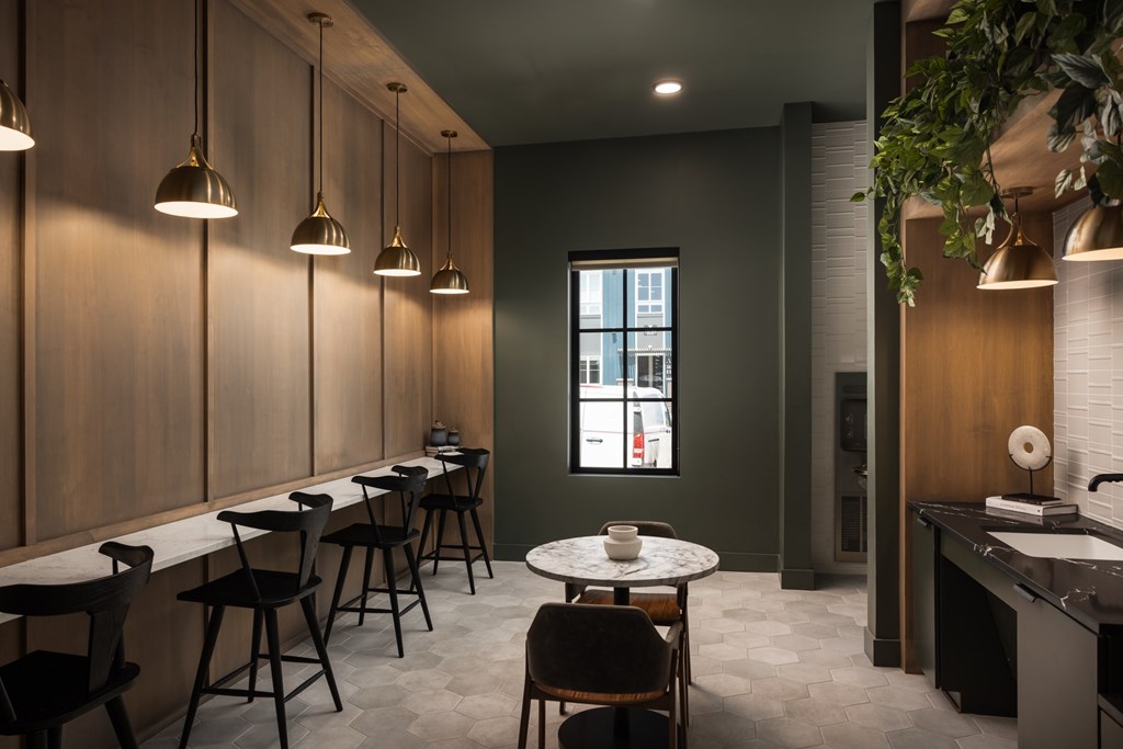 A modern dining area with a long table and chairs.