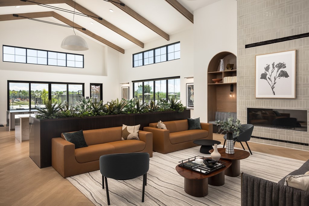 A living room with a fireplace and a large window.