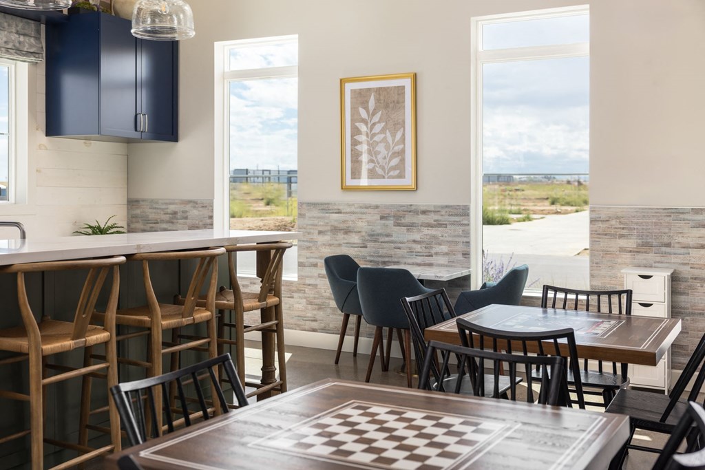 a dining room with a checkered table and chairs and a view of the