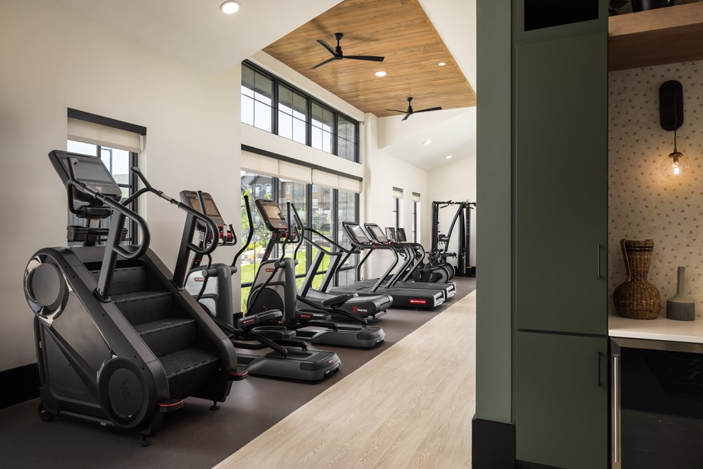 A gym with treadmills, elliptical machines, and a stair climber.