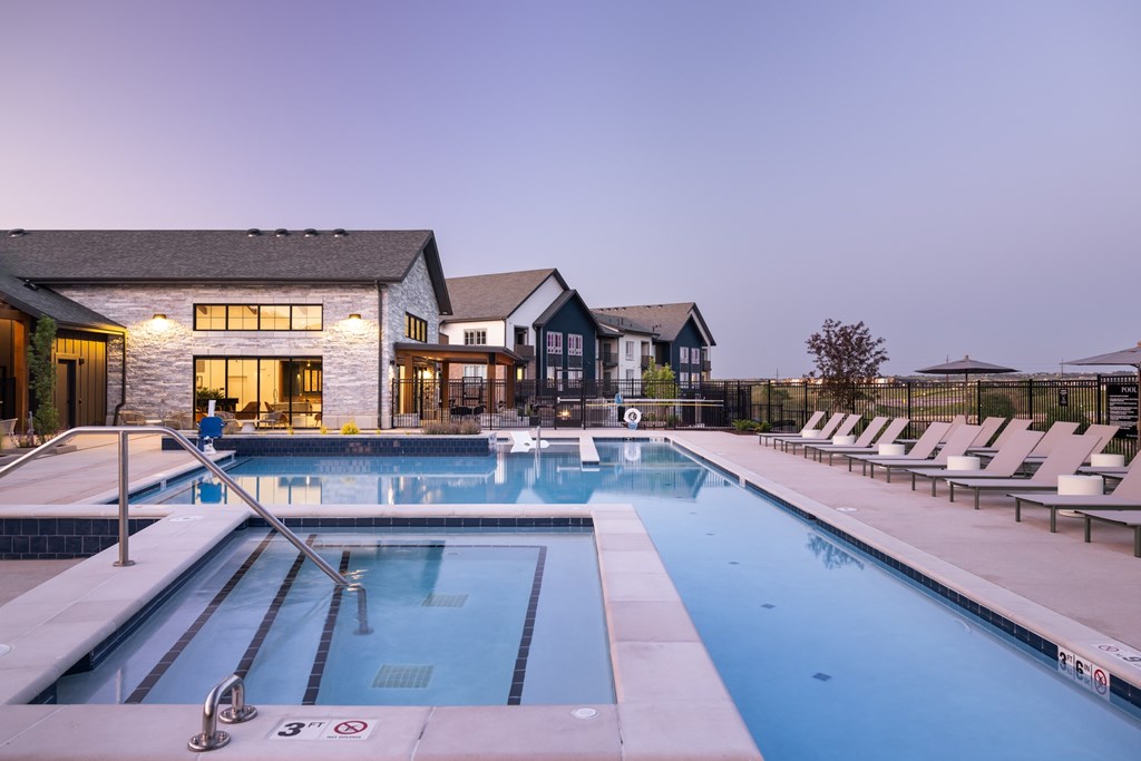 A large swimming pool with lane markers and a diving board.