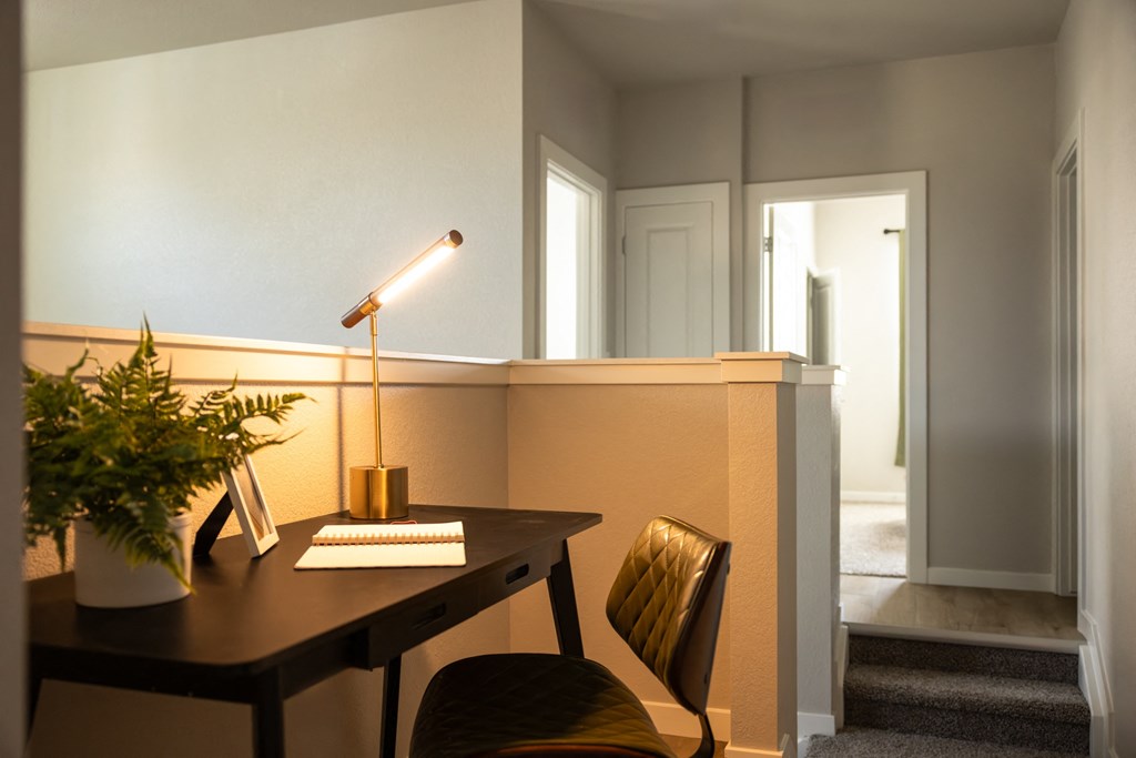 a dining room with a table and chairs and a lamp