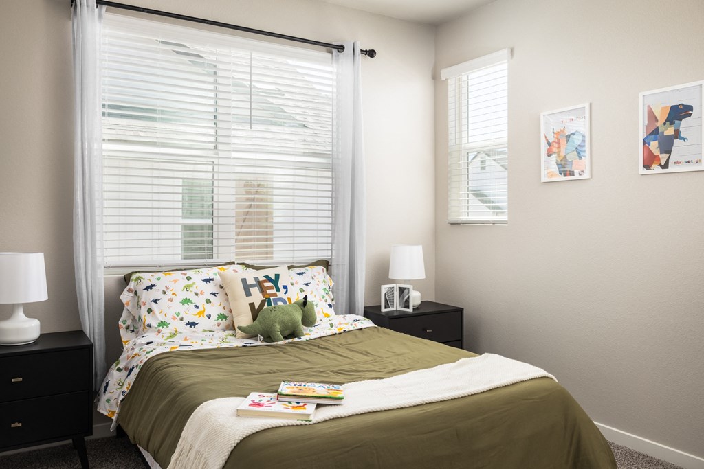 a bedroom with a bed with a stuffed animal on it