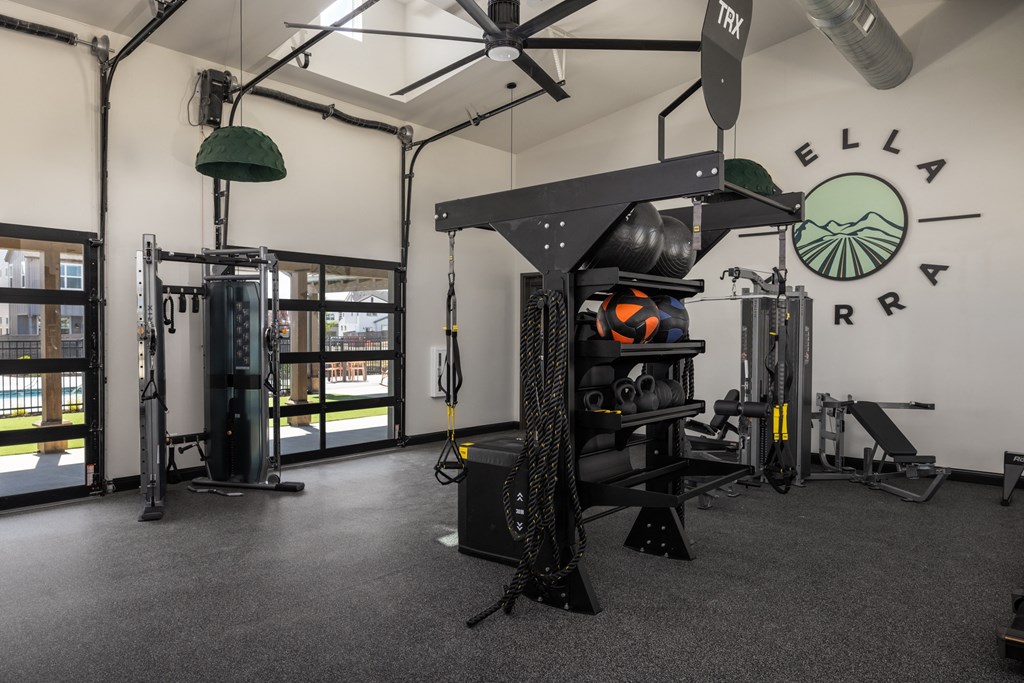 a fitness room with weights and cardio equipment in a gym