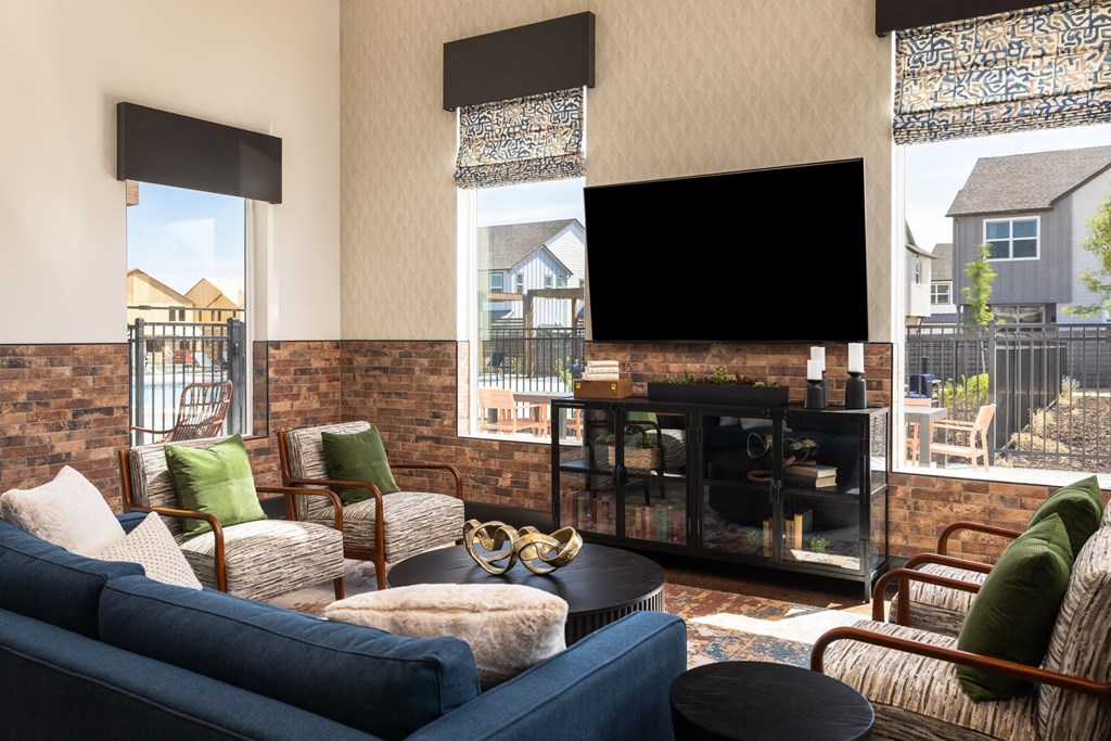 a living room with a blue couch and chairs and a fireplace