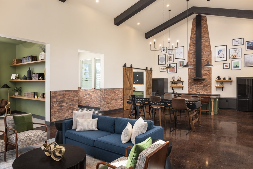 a living room with a blue couch and a table and chairs