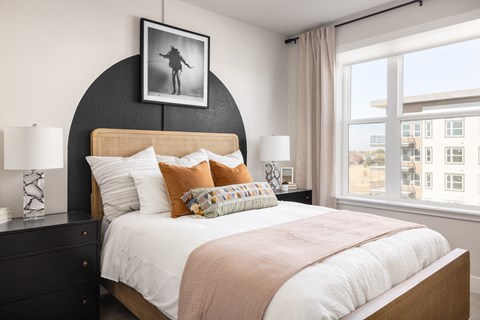 a bedroom with a large bed and a large window