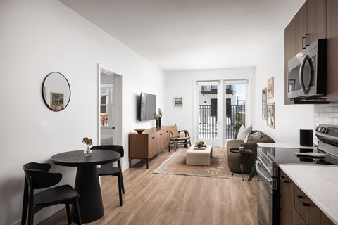 A modern kitchen with a dining table and chairs.