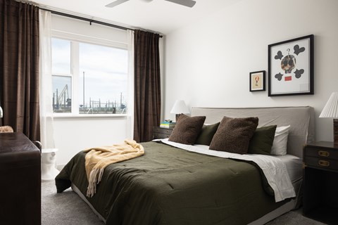 A bedroom with a large bed and a view of the water.