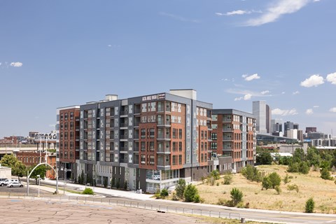 A large multi-story building with a parking lot in front.