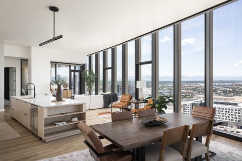 A modern kitchen with a dining table and chairs.
