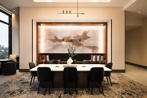 A modern dining room with a large table and chairs.