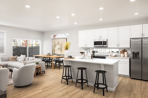A modern kitchen with white cabinets and a large island.