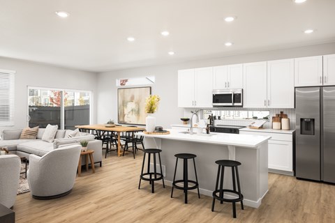 A modern kitchen with white cabinets and a large island.