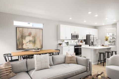 A modern living room with a grey sofa and a painting on the wall.