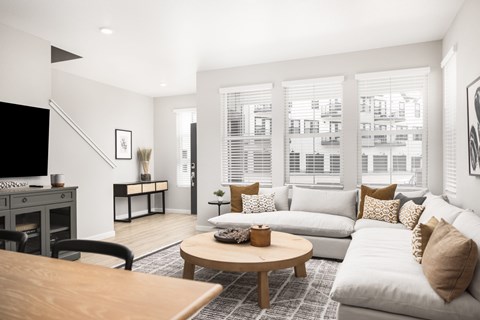 A living room with a white couch and a coffee table.