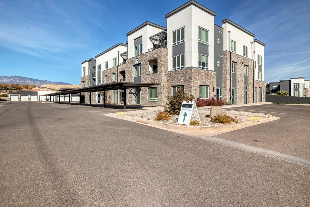 an empty parking lot in front of an apartment building