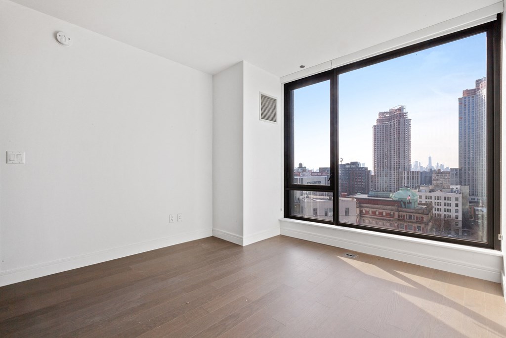 a living room with a large window overlooking a city