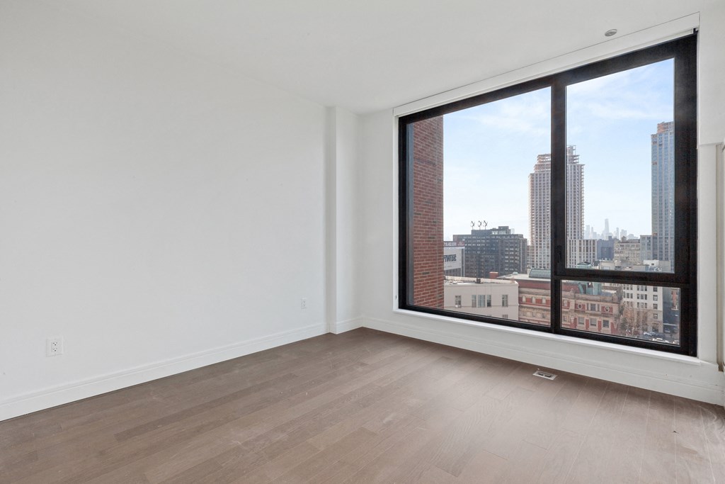 an empty room with a large window overlooking a city