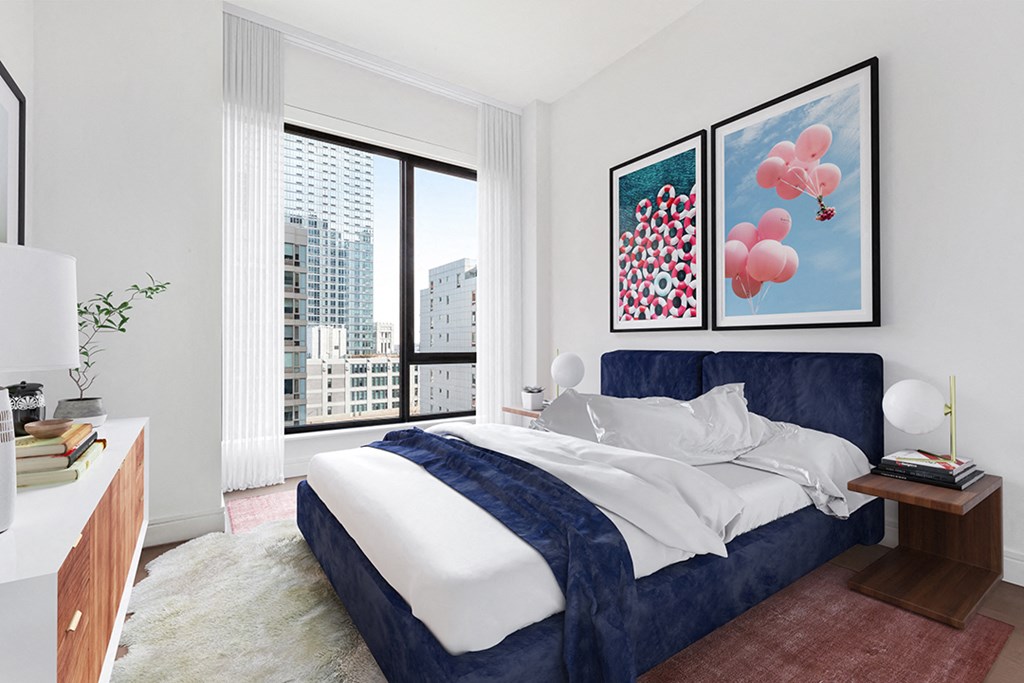 a bedroom with a bed and a large window