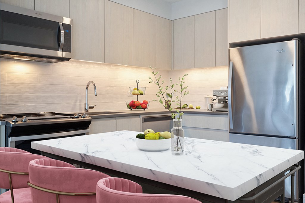 a kitchen with a marble table and pink chairs