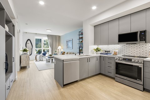 A modern kitchen with a large island and stainless steel appliances.