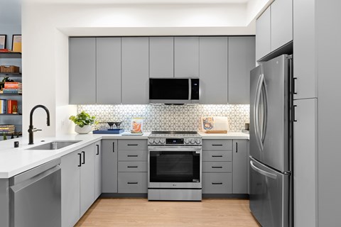 A modern kitchen with a refrigerator on the right.