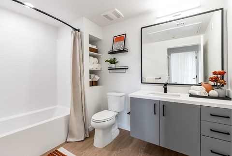 A bathroom with a toilet, sink, and bathtub.