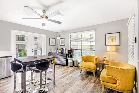 A dining room with a table and chairs.