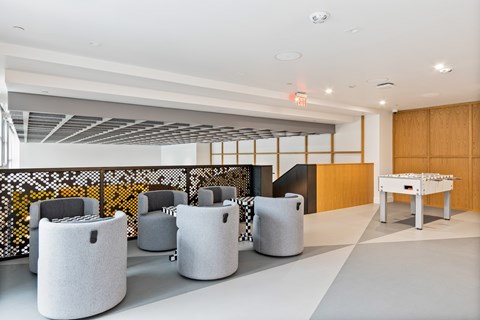 A room with white chairs and a wooden cabinet.