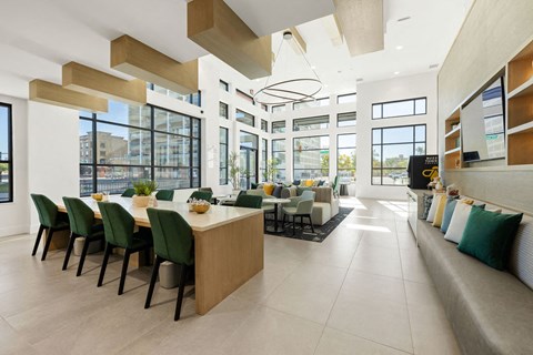 a dining room and living room with a long table and chairs