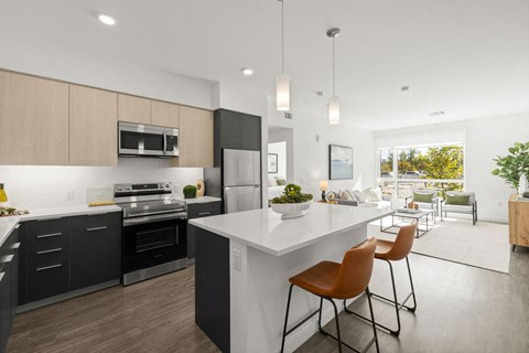 a kitchen and living room with a white counter top