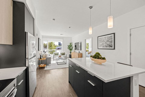a view of a kitchen and a living room from a hallway