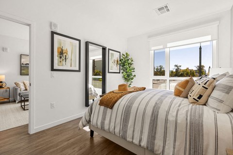 a bedroom with a bed and some windows