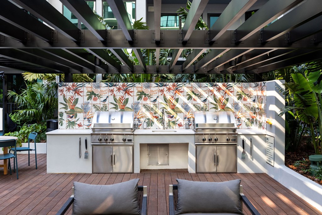 A modern outdoor kitchen with a grill and sink.