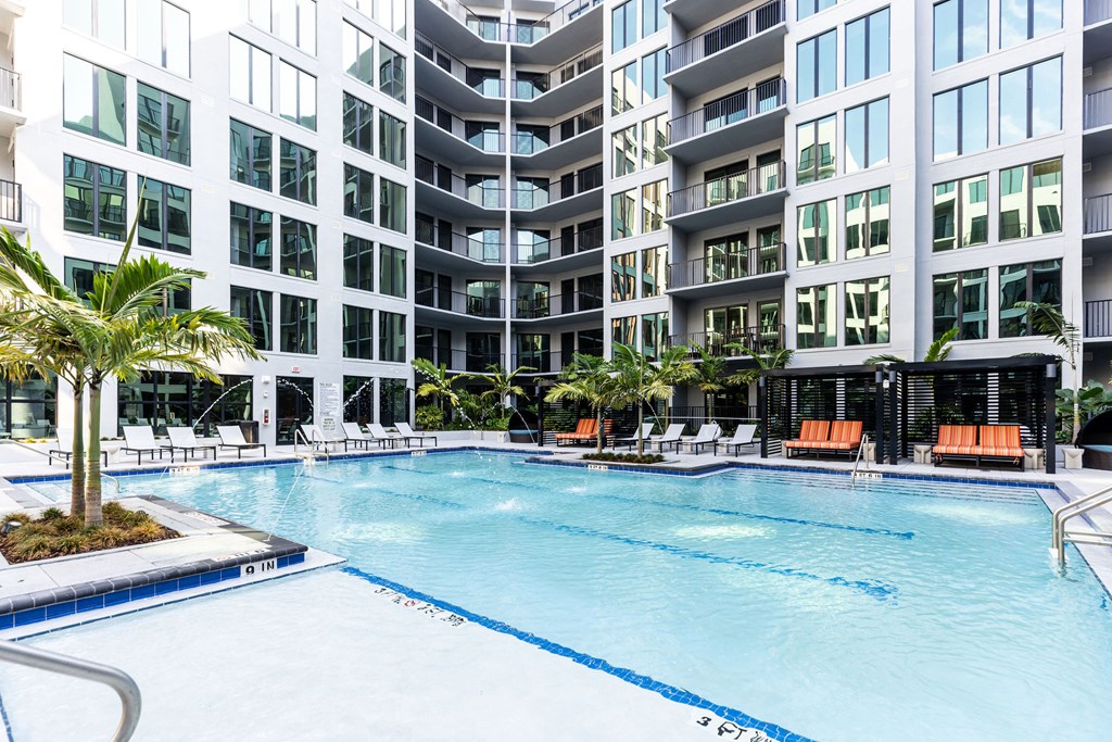 A large swimming pool in front of a modern building.