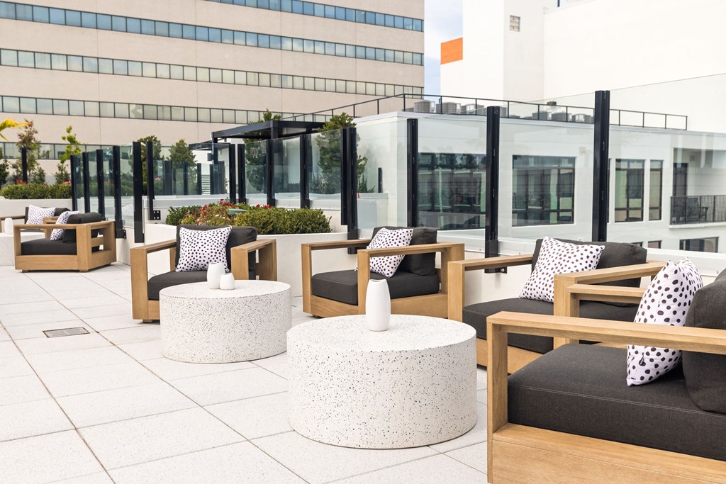 A patio with white and brown furniture.
