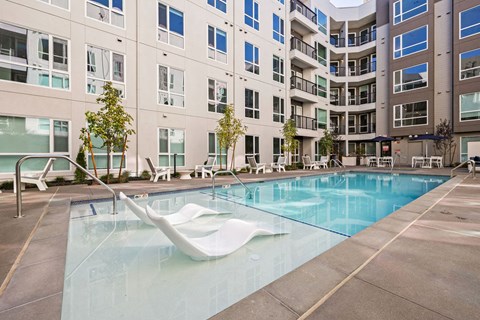 a swimming pool in front of an apartment building