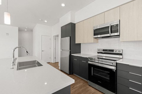 a kitchen with black appliances and white counter tops