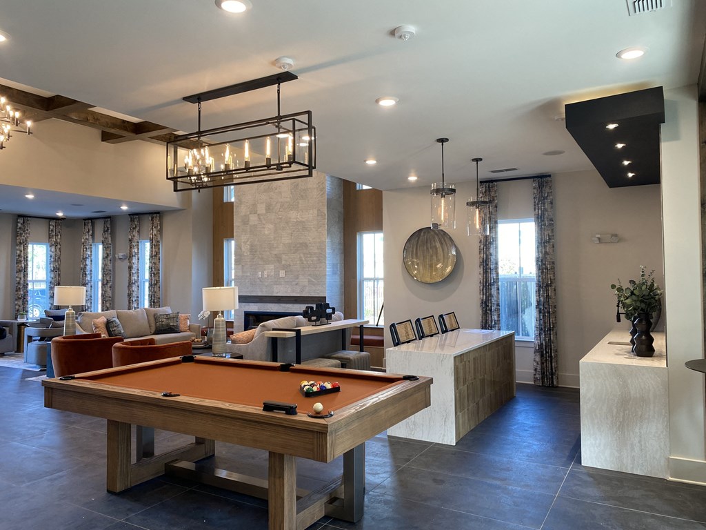 a clubhouse with a pool table and a entertainment