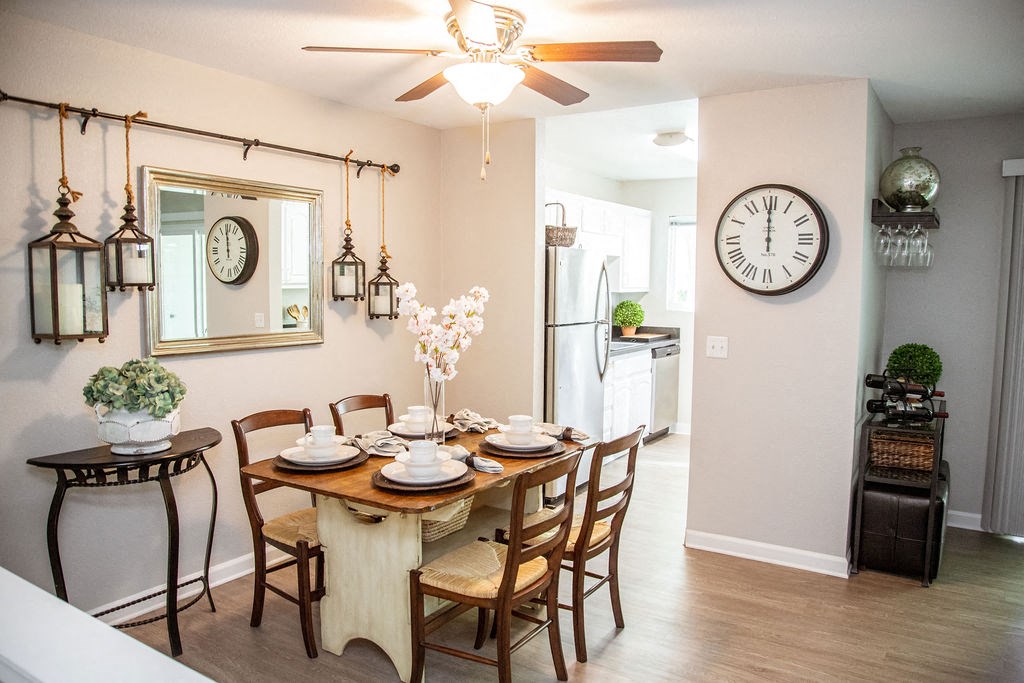 a dining room with a table and a clock on the wall