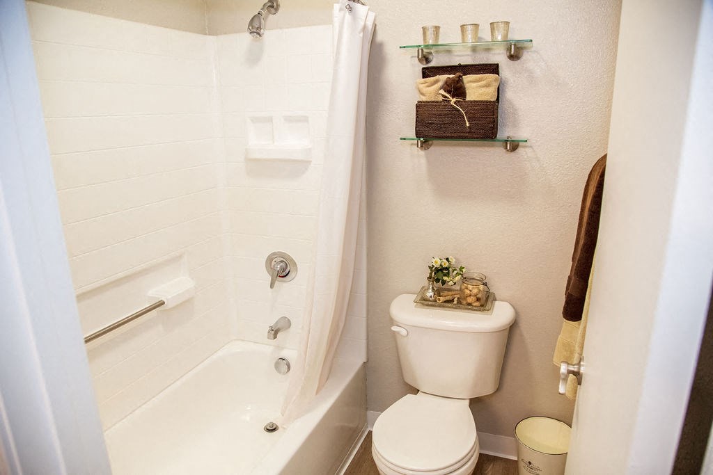 a small bathroom with a toilet and a shower